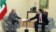 Prime Minister Saad Hariri (R) hands President Michel Aoun his government's resignation at the Baabda presidential palace, east of the capital Beirut, on October 29, 2019, bowing to nearly two weeks of unprecedented nationwide protests. AFP / Dalati And N