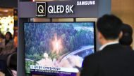 People watch a television news screen showing file footage of a North Korean missile launch, at a railway station in Seoul on October 31, 2019. AFP / Jung Yeon-je