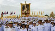 Thai officials pay respect next to a picture of Thailand's King Maha Vajiralongkorn outside the Grand Palace in Bangkok, Thailand, July 28, 2019.  Reuters/Athit Perawongmetha