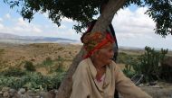 Grandmother Massouda Barhoumi sits under a tree on her family's land, which is a 4km walk from the nearest source of water, in the central region of Kairouan, Tunisia on September 2, 2019. Thomson Reuters Foundation/Layli Foroudi