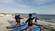 Young Indonesian female surfers seen during a practice session in Lombok, Indonesia October 8, 2019. Thomson Reuters Foundation/Beh Lih Yi
