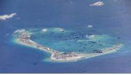 Chinese dredging vessels are purportedly seen in the waters around Mischief Reef in the disputed Spratly Islands in the South China Sea, May 21, 2015. US Navy Handout via Reuters