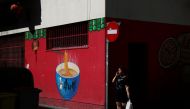 A woman walks past a Chinese food store at Usera district in Madrid, Spain, July 24, 2017. Reuters / Susana Vera