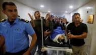 People wheel the dead body of Palestinian man Omar al-Badawi at a hospital in Hebron, in the Israeli-occupied West Bank November 11, 2019. Reuters/Mussa Qawasma