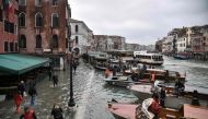 A general view shows the flooded embankment by the Hotel Rialto (L) and taxi boats on the Grand Canal channel, as seen from the Rialto bridge, after an exceptional overnight 