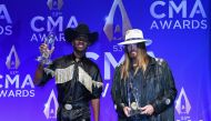 Lil Nas X and Billy Ray Cyrus speak backstage with their Musical Event of the Year award for 