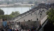 Iraqi demonstrators smash concrete walls at Sinak Bridge during the ongoing anti-government protests, in Baghdad, Iraq November 16, 2019. REUTERS/Wissm al-Okili