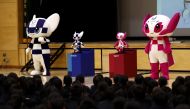Tokyo 2020 Olympic and Paralympic Games' mascots and robot-type mascots Miraitowa (L) and Someity (R) attend a ceremony at Hoyonomori elementary school in Tokyo on November 18, 2019.  / AFP / Behrouz MEHRI 