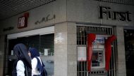 Two women walk past a closed bank office in Beirut, Lebanon November 15, 2019. Reuters/Andres Martinez Casares
 