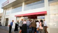 People queue outside a branch of BLC bank in Sidon, Lebanon November 19, 2019. REUTERS/Ali Hashisho