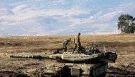 Israeli soldiers and armoured vehicles are pictured on November 19, 2019 near the border with Syria in the annexed Golan Heights. AFP / JALAA MAREY