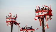 People attend a parade, on the 76th anniversary of Lebanon's independence, from a crane platform at Martyrs' Square in Beirut, Lebanon November 22, 2019. Reuters/Andres Martinez Casares