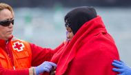 A pregnant woman is helped by a member of medical staff after arriving aboard a Spanish maritime rescue boat, after being rescued at sea north of Spain's Canary Islands, on the island of Las Palmas de Gran Canaria, Spain, November 22, 2019. Reuters/Borja 
