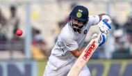India's captain Virat Kohli plays a shot during the second day of the second Test cricket match of a two-match series between India and Bangladesh at the Eden Gardens cricket stadium in Kolkata on November 23, 2019. (AFP / Dibyangshu SARKAR)