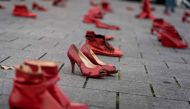 A picture taken on November 24, 2019, in Brussels shows red shoes set up on the ground for the victims during a protest to condemn violence against women. AFP / Kenzo Tribouillard
 