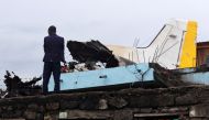 A man stands at the site where a Dornier 228-200 plane operated by local company Busy Bee crashed into a densely populated neighborhood in Goma, eastern Democratic Republic of Congo November 24, 2019. REUTERS/Fiston Mahamba
