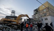 Emergency personnel work near a damaged building in Thumane, after an earthquake shook Albania, November 26, 2019. REUTERS/Florian Goga
