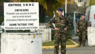 French soldiers stand on November 26 2019 at the entrance to the base of the 5th RHC (Fighter Helicopter Regiment) in Uzein, southwestern France, where were affected seven of the 13 soldiers killed in the helicopter crash in Mali. AFP / GAIZKA IROZ