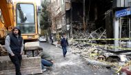 File photo of people walk near a burnt bank, after protests against increased fuel prices, in Tehran, Iran November 20, 2019.  Nazanin Tabatabaee/WANA (West Asia News Agency) via REUTERS 
 