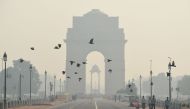 Indian pedestrians walk near the India Gate monument amid heavy smog in New Delhi (AFP file photo) 