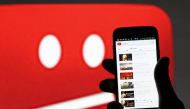 A picture illustration shows YouTube on a cell phone in front of a YouTube copyright message regarding a video on an LCD screen in central Bosnian town of Zenica, June 18, 2014. Reuters / Dado Ruvic