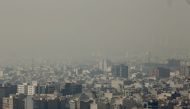 In this file photo taken on November 13, 2019 A general view taken from Western Tehran shows a blanket of brown-white smog covering the city as heavy pollution hit the Iranian capital on November 13, 2019. / AFP / ATTA KENARE 