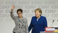 Annegret Kramp-Karrenbauer greets delegates while she stands next to Angela Merkel after she has been elected as new CDU party leader in Hamburg Germany on December 7, 2018. (Abdülhamid Ho?ba? / Anadolu Agency) 