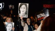 File photo: Protesters hold up placards and pictures of the late journalist Daphne Caruana Galizia as they gather outside the prime minister office in Valletta, Malta on November 20, 2019. AFP / Matthew Mirabelli