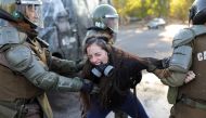 A demonstrator reacts as she is detained by riot policemen during a protest against Chile's government in Santiago, Chile, November 30, 2019. Reuters/Pablo Sanhueza