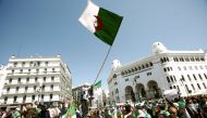 People carry national flags during a protest to demand the removal of of the then president Abdelaziz Bouteflika in Algiers, Algeria, March 29, 2019. Reuters / Ramzi Boudina