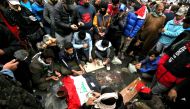 Iraqi protesters mourn and pray at the site where 17 people at least were killed and dozens more wounded overnight at Al-Khilani square in the capital Baghdad, amid ongoing anti-government demonstrations on December 7, 2019.  AFP / SABAH ARAR