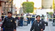Police officers guard a crime scene where four people were killed and two injured in a shooting near Mexico's National Palace, the presidential residence in the capital's historic downtown, officials said, in Mexico City, Mexico December 7, 2019. REUTERS/