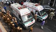 Police personnel and ambulances are seen along a road following a factory fire in Anaj Mandi area of New Delhi on December 8, 2019  / AFP / Sajjad HUSSAIN