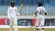 Sri Lanka's Dhananjaya de Silva (L) celebrates with teammate Niroshan Dickwella after scoring half century (50 runs) during the second day of the first Test cricket match between Pakistan and Sri Lanka at the Rawalpindi Cricket Stadium in Rawalpindi on De