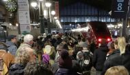 Commuters wait to take a train at Gare du Nord train station during a strike by all unions of French SNCF workers and the Paris transport network (RATP), as France faces its tenth consecutive day of strikes against French government's pensions reform plan