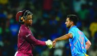 West Indies' Shimron Hetmyer (L) gestures along with India's Deepak Chahar as he walks back to the pavilion after he got caught during the first one day international cricket match of a three-match series between India and West Indies, at the M.A. Chidamb