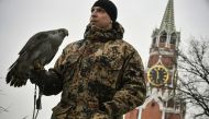 Alexei Vlasov a 28-year-old falconer of the Kremlin ornithological service holds Alpha, a 20-year-old female goshawk while patrolling in Moscow on March 21, 2019. AFP / Alexander Nemenov