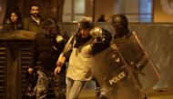 Riot police detain an anti-government demonstrator during clashes in the capital Beirut on December 14, 2019. AFP / Anwar Amro