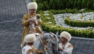 Turkmenistan's President Gurbanguly Berdymukhamedov holds a Turkmen shepherd dog - locally known as Alabai - while mounted on a horse as he takes part in celebrations for the Day of the Horse in Ashgabat in this file photograph taken on April 28, 2018. AF