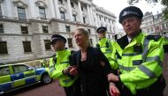 Police take away a protestor during an Extinction Rebellion demonstration outside the Treasury building in London, Britain October 3, 2019. Reuters / Simon Dawson
