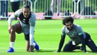 Liverpool’s Virgil van Dijk (left) and Mohamed Salah during a practice session in Doha, yesterday..