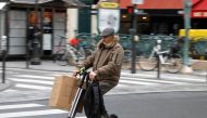A man rides an electric scooter or 