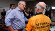 Australia's Prime Minister Scott Morrison greets a volunteer during a visit to the Wollondilly Emergency Control Centre in Sydney, Australia, December 22, 2019. AAP Image/Joel Carrett/via Reuters