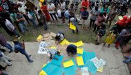 Demonstrators prepare placards before attending a protest march against a new citizenship law, in Kochi, India, December 23, 2019. (REUTERS/Sivaram V)