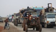 Trucks carry belongings of people fleeing from Maarat al-Numan, in northern Idlib, Syria December 24, 2019. Reuters/Mahmoud Hassano