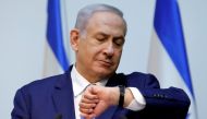 Israeli Prime Minister Benjamin Netanyahu looks at his watch before delivering a statement at the Knesset, Israeli parliament, in Jerusalem. December 19, 2018. Reuters / Amir Cohen