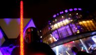 A fan dressed as Kyle Ren awaits at a gala screening of 