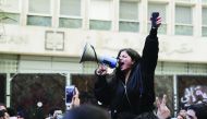 A Lebanese anti-government demonstrator yells slogans as she takes part in a rally in front of the central bank building in the capital Beirut on December 30, 2019.  AFP / Anwar Amro