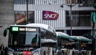 The logo of French national railway operator SNCF is seen as buses arrive outside Gare Montparnasse train station in Paris on January 2, 2020 on the 29th day of a nationwide multi-sector strike against the government's pensions overhaul. AFP / Stephane De