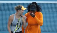 Serena Williams (R) of the US and Caroline Wozniacki of Denmark talk between points against Nao Hibino and Makoto Ninomiya of Japan during their women's doubles first round match during the Auckland Classic tennis tournament in Auckland on January 6, 2020